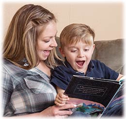 Parent reading a song book with a child